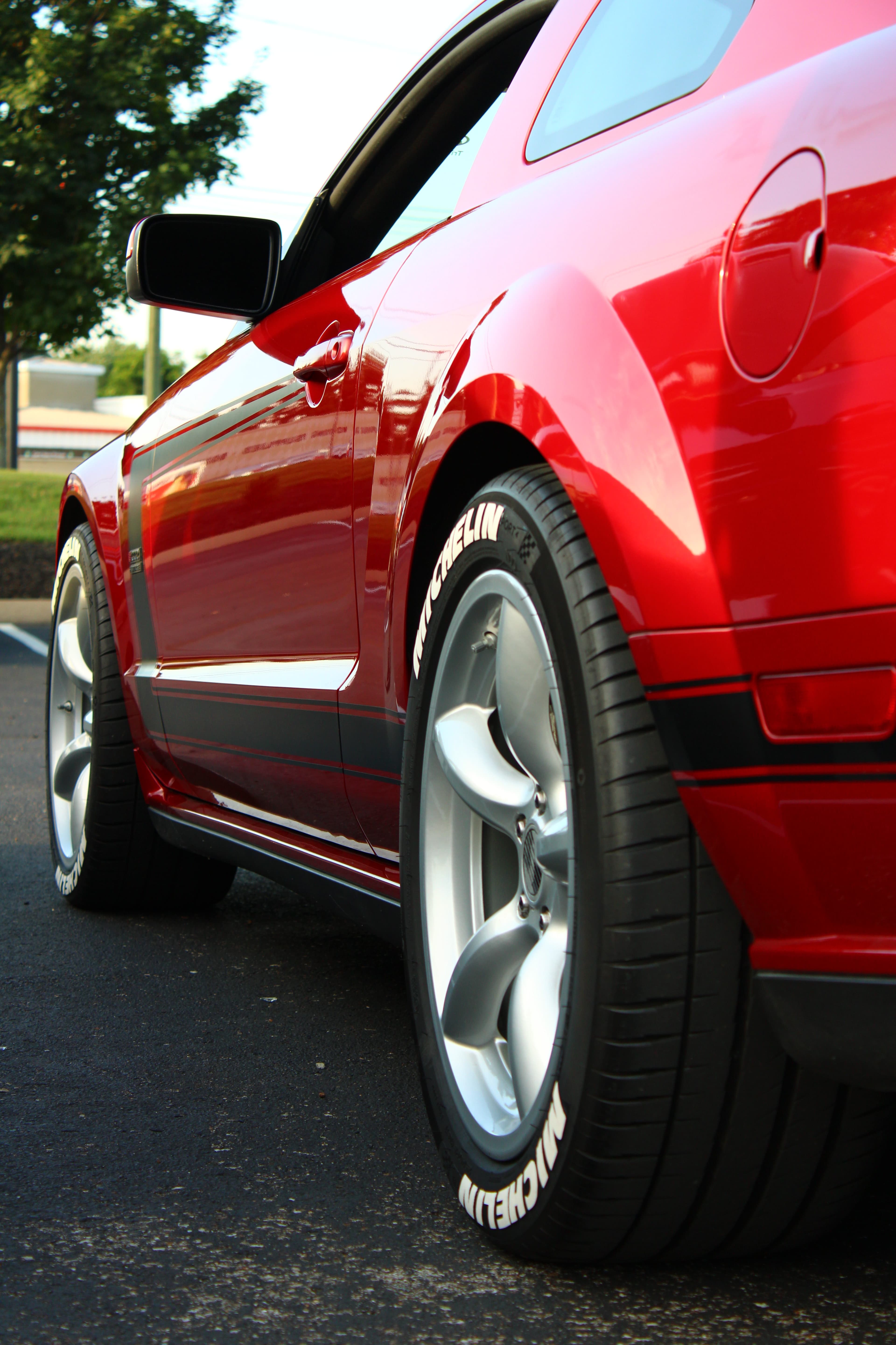 Red Ford Mustang side profile with wheel detail