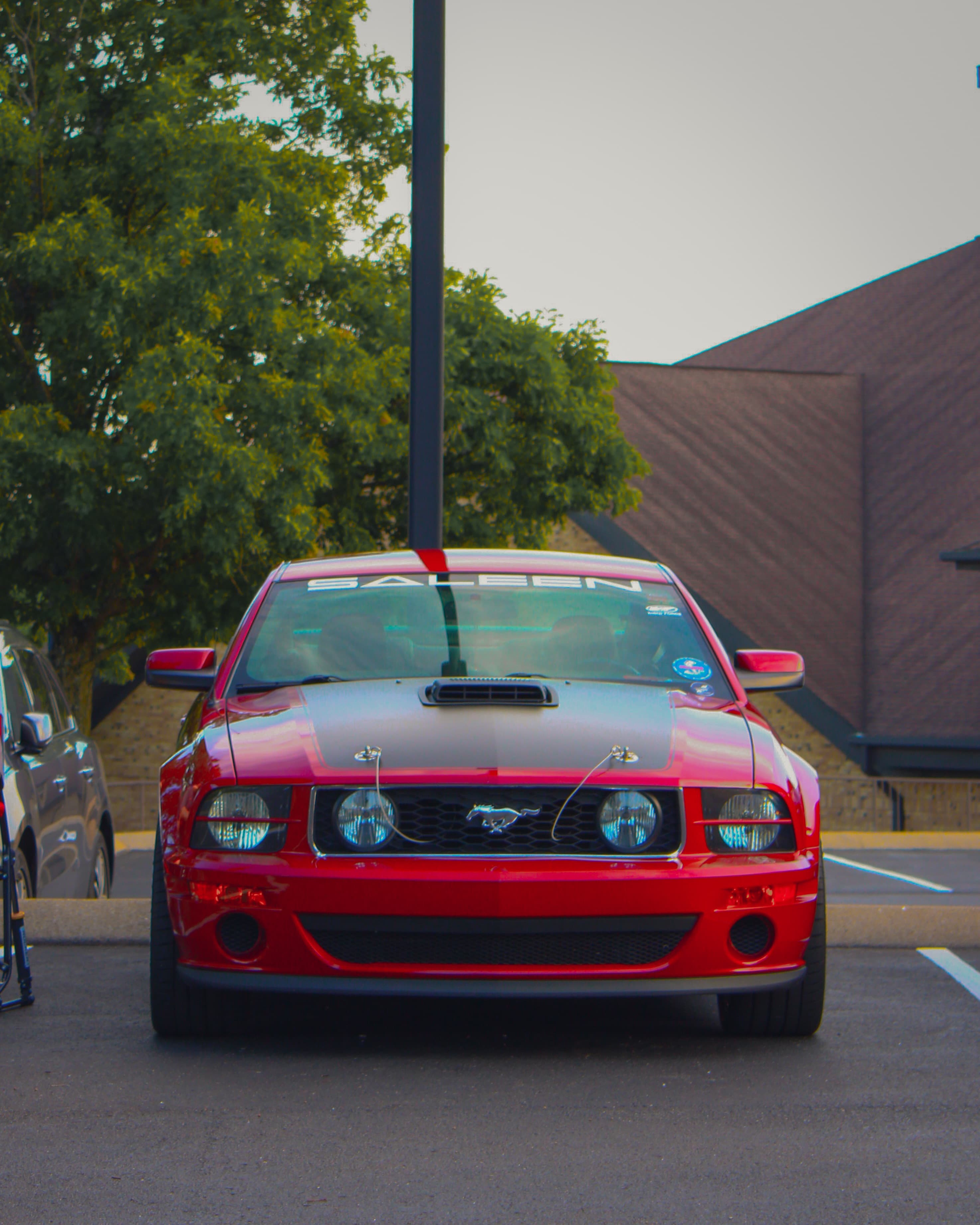 Red Ford Mustang front view in parking lot