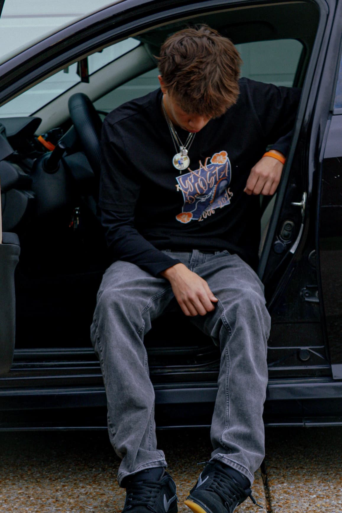 Portrait seated in car doorway