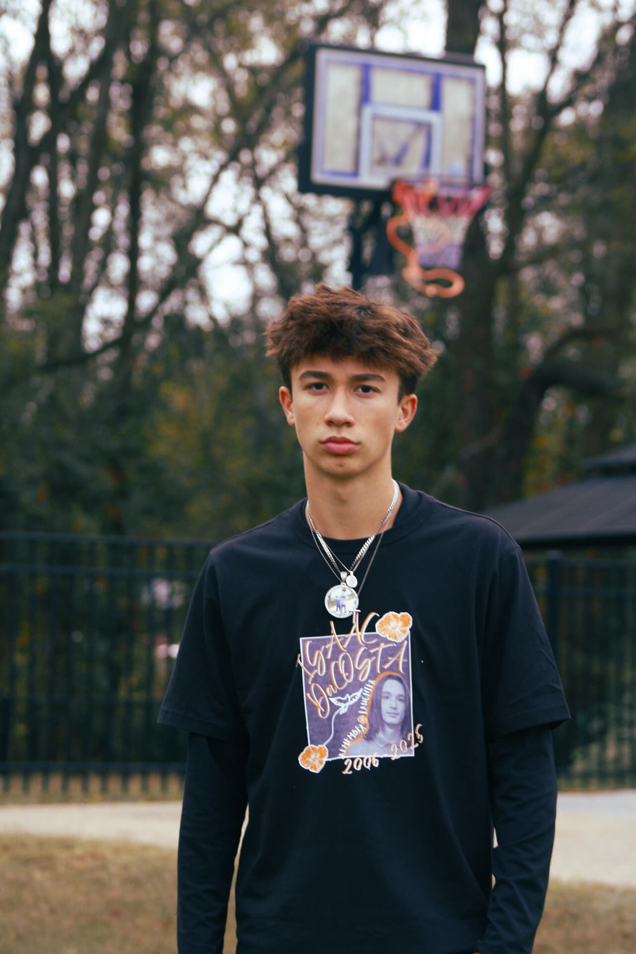 Portrait with basketball court in background